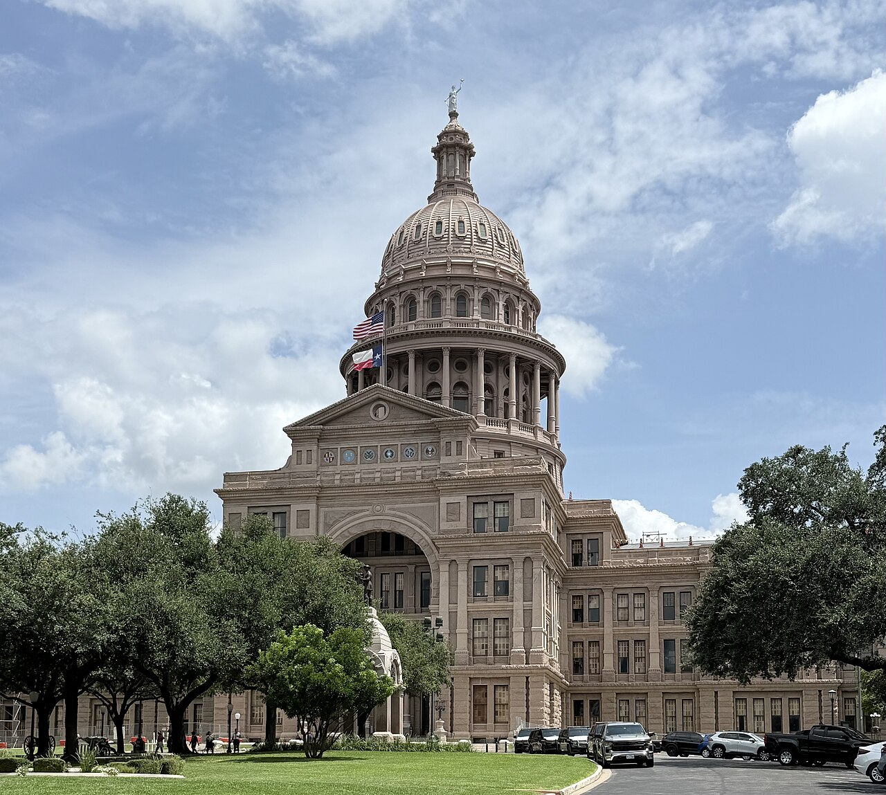 The Texas State Capitol in Austin, with the U.S. and Texas flags flying.